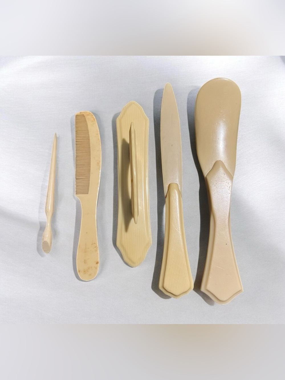 Vintage 1920s set with five French ivory & five celluloid grooming implements.